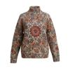 Front view of a luxury women's turtleneck sweater with a detailed jacquard regina pattern in burnt orange, red, and blue on a beige background.