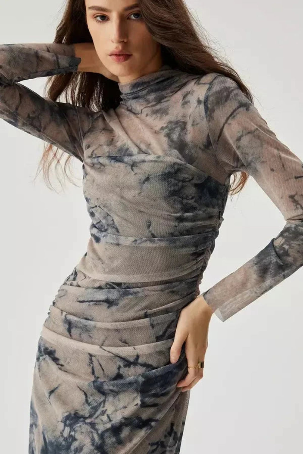 Model wearing the Kouvr Fashion long sleeve ruched mesh midi dress in a storm multicolor tie-dye print