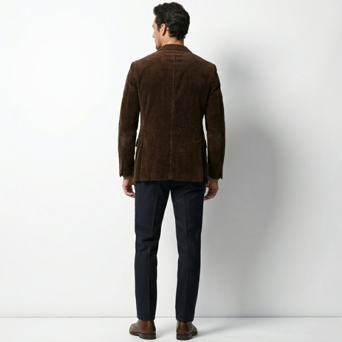 Rear view of the Kouvr Fashion men's brown corduroy blazer showing the fit and double vent detail.
