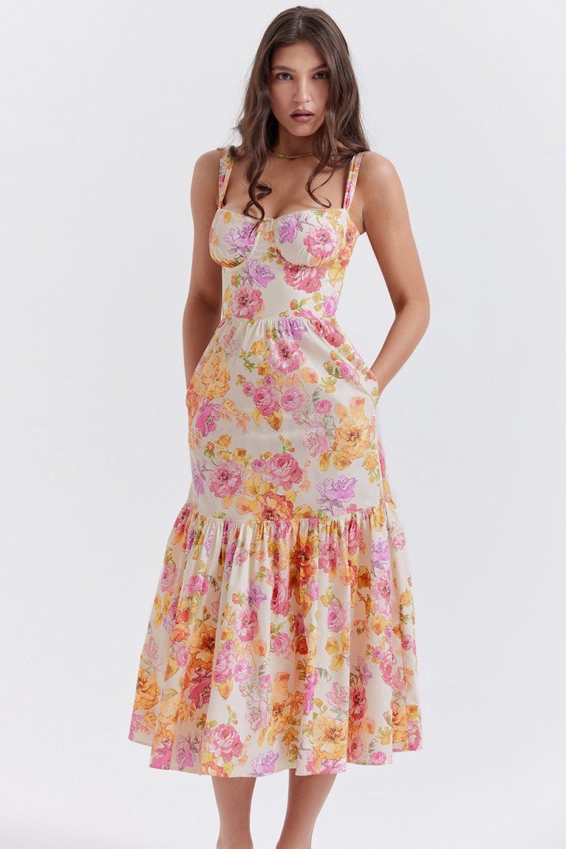 Model with hands in the side pockets of The Persephone floral bustier midi dress, showcasing its functional design.