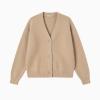 Flat lay of a beige V-neck cashmere cardigan with horn buttons, showing the texture of the luxury knit.