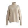 Studio product shot of the Kouvr gloria cashmere turtleneck pullover in beige on a grey background.