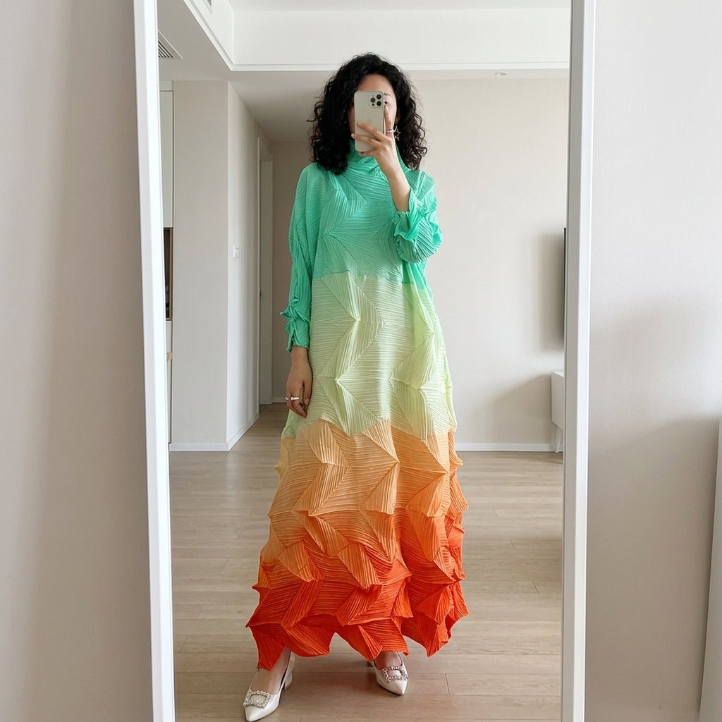 Lifestyle mirror selfie of woman wearing the Kouvr mint to orange pleated maxi dress showcasing the relaxed, flowing fit.