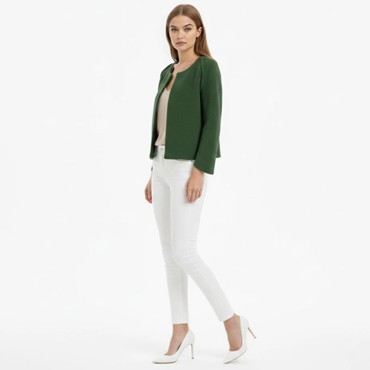 Side profile of a model wearing the forest green Kouvr Laverne cropped jacket, showcasing its structured silhouette and wide sleeves.