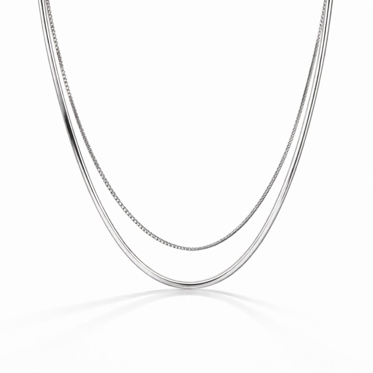 A dual-strand layered silver necklace from Kouvr featuring a flat snake chain and a dainty box chain on a white background. 