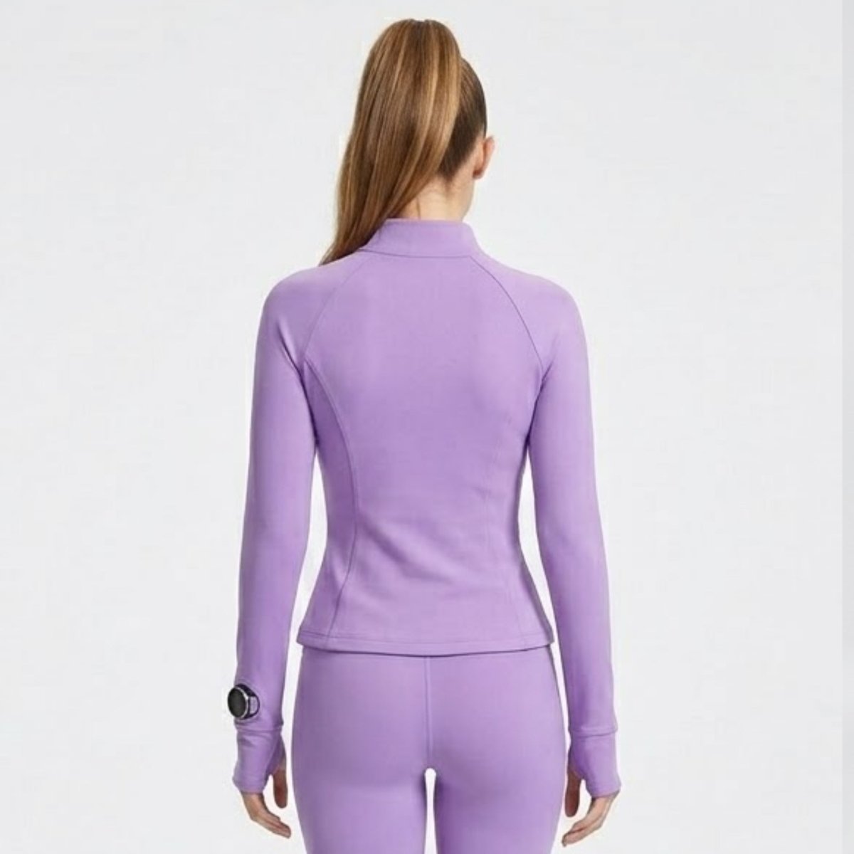 Back view of women's luxury light purple  athletic zip-up jacket showing tailored contour seam details.