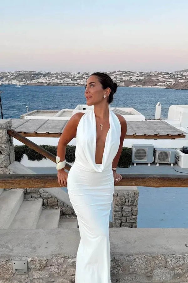 Model wearing the white satin backless Meliora Gown by Kouvr Fashion