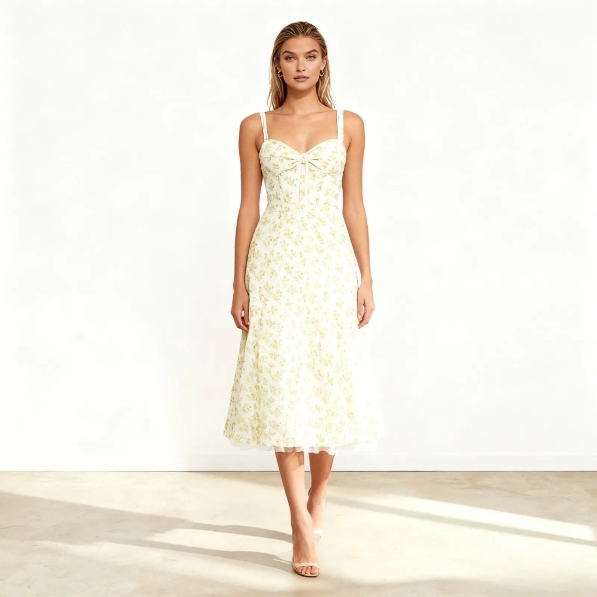 Model wearing the Kouvr Fashion white floral midi dress with sweetheart neckline, shown from the front against a white background. 