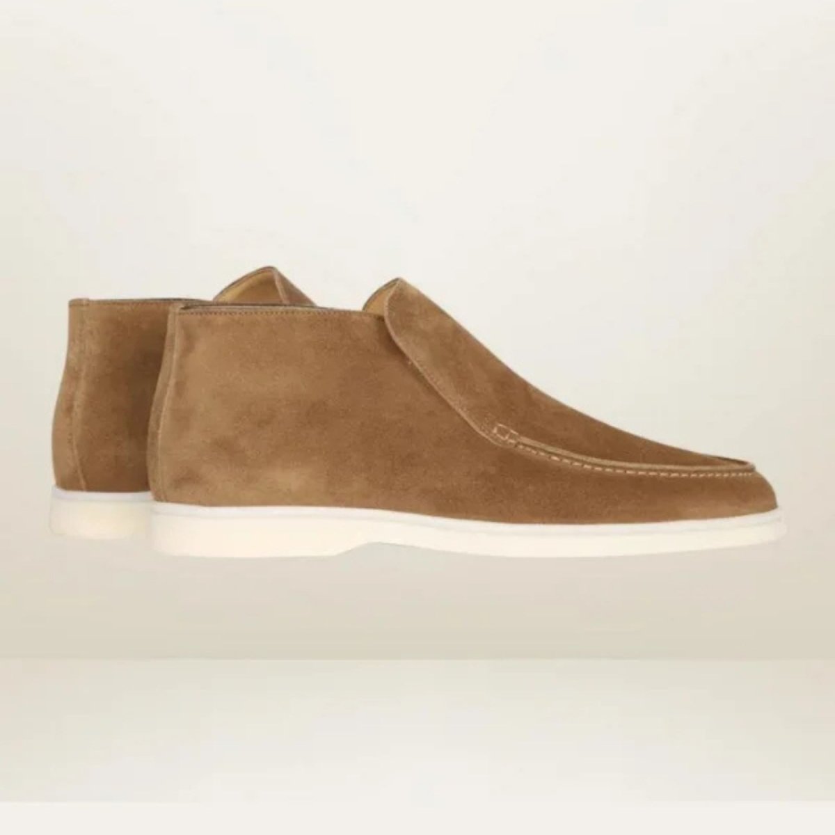 A pair of men's brown suede loafer boots with white soles, displayed against a clean, white studio background to show product details.
