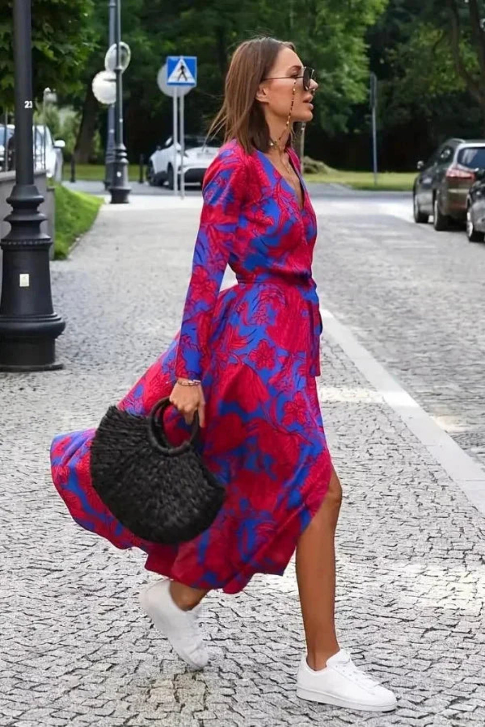 Side view of the Aleia long sleeve silk wrap dress showing the high-low hem and movement.
