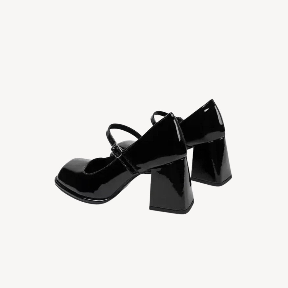 Rear view of the Kouvr Sabrina pumps, focusing on the architectural shape of the chunky block heels and the clean lines of the shoe's construction.