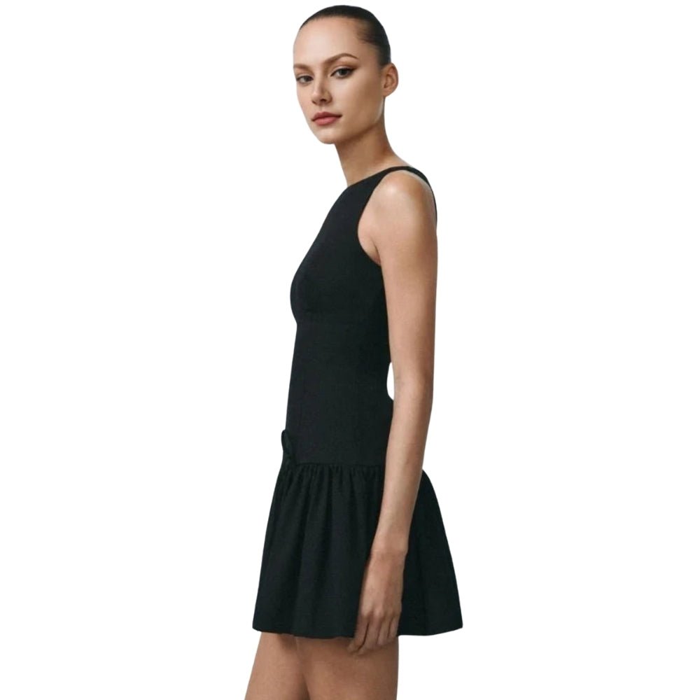 Black Kouvr  sleeveless dress worn by a model on a white background