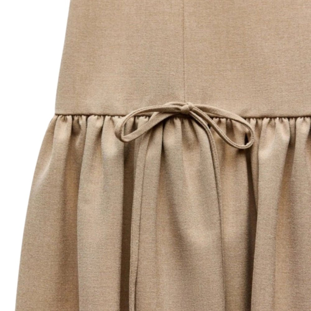Close-up of a  Khaki Kouvr  skirt with a tie waist on a white background