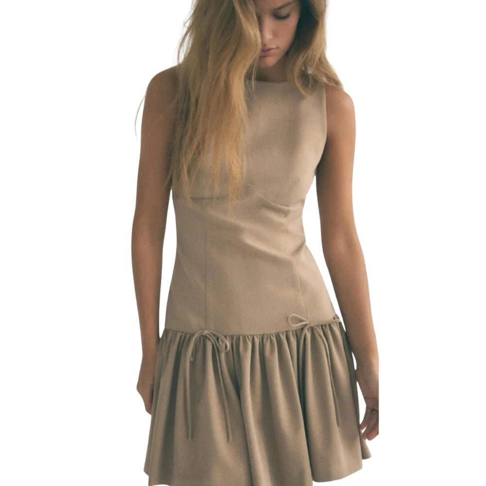 Woman wearing a  Khaki Kouvr dress on a white background