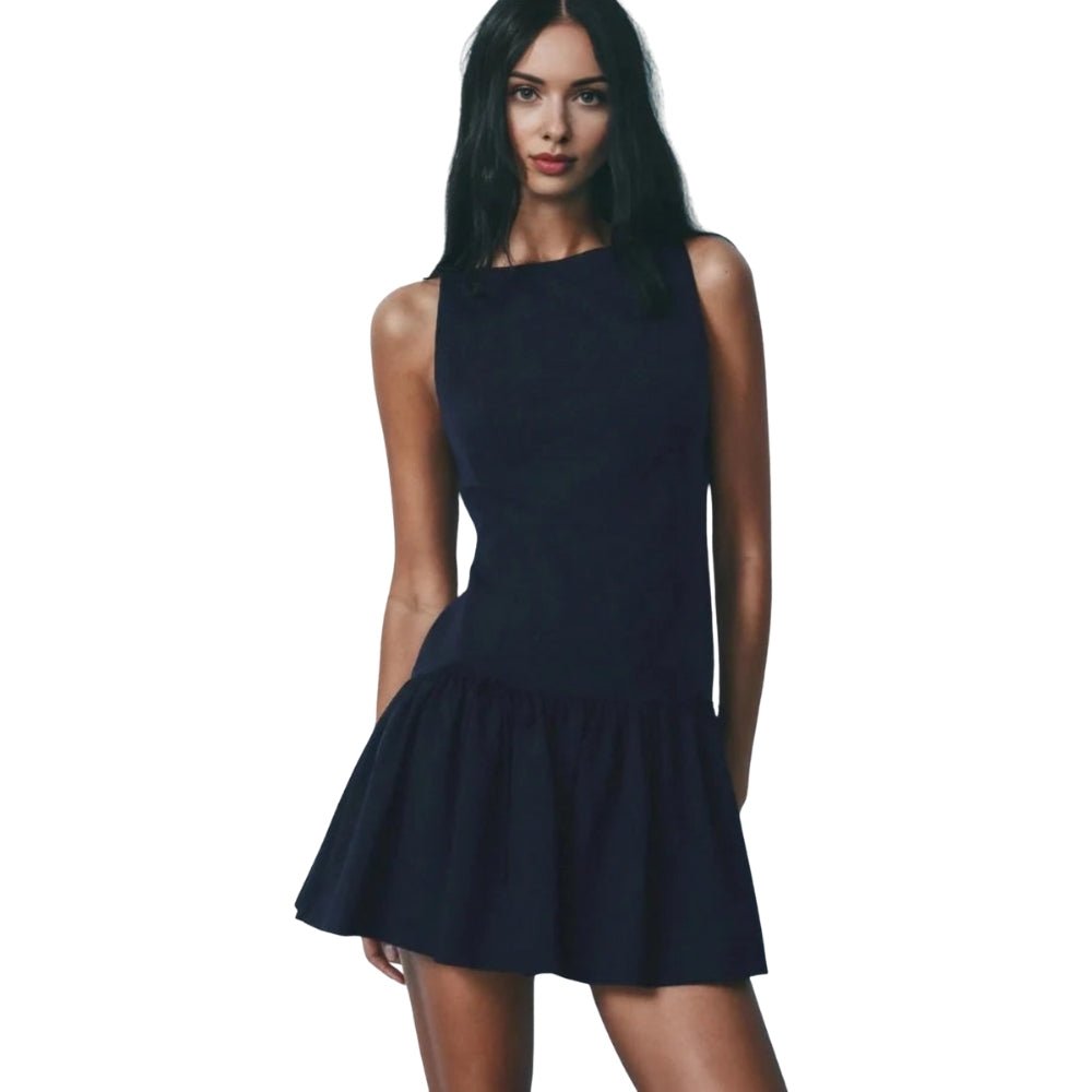 Woman wearing a navy Kouvr dress on a white background