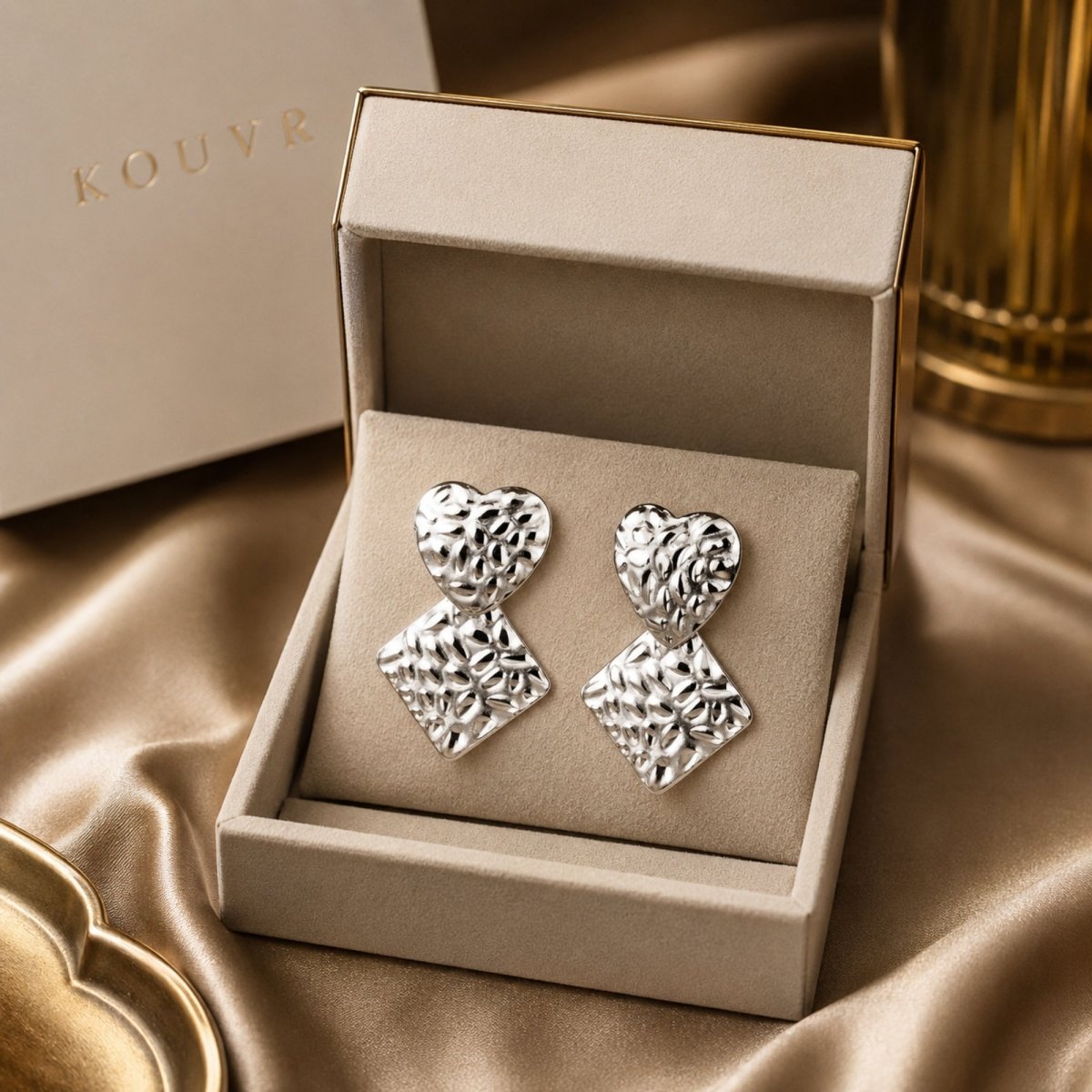 Kouvr hammered silver heart and diamond drop statement earrings displayed in premium branded soft touch packaging