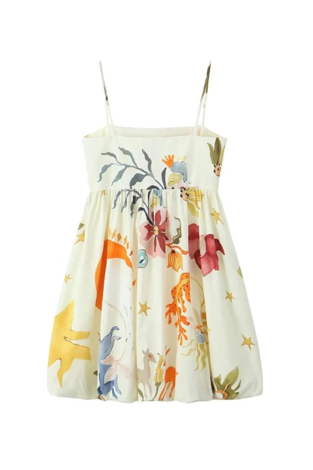 Woman wearing Kouvr Solana artistic print voluminous mini dress in a sunny outdoor setting