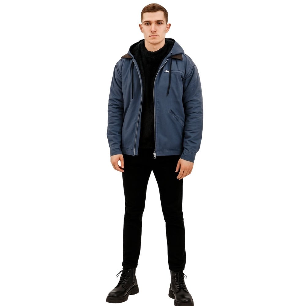 Man wearing the Kouvr tyrian sherpa-lined blue canvas hooded jacket, facing front with hands in pockets.