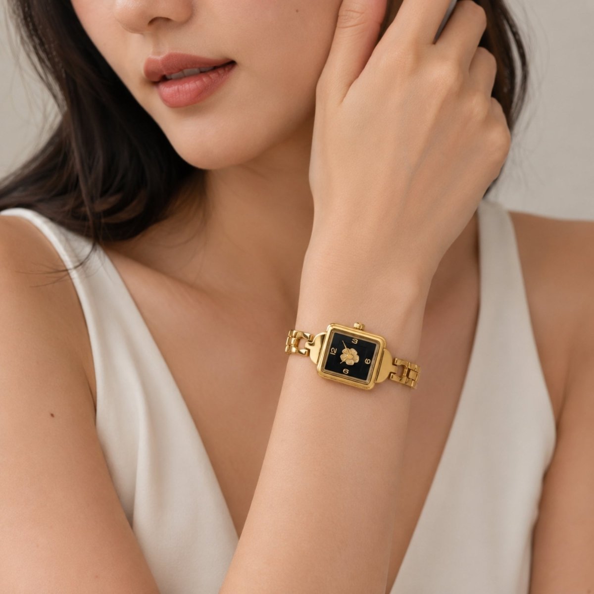 Elegant woman wearing the Kouvr gold square vintage watch demonstrating the jewelry chain link strap on the wrist