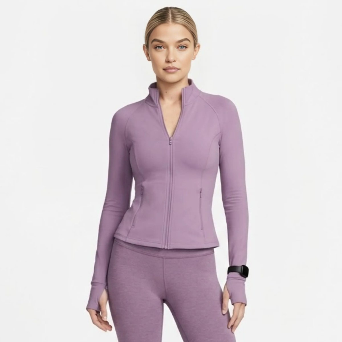 Front view of woman wearing Kouvr premium purple  fitted athletic zip-up jacket with thumbholes
