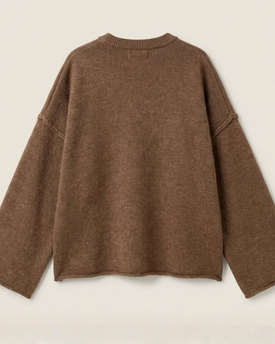 Back view flatlay of the oversized brown pullover sweater, showing the ribbed collar detail and overall shape.