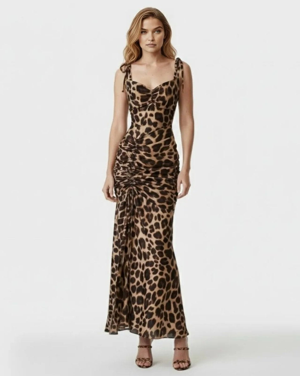 Model wearing the leopard print maxi dress, showing the front view with sweetheart neckline, tie-shoulders, and extensive ruching.