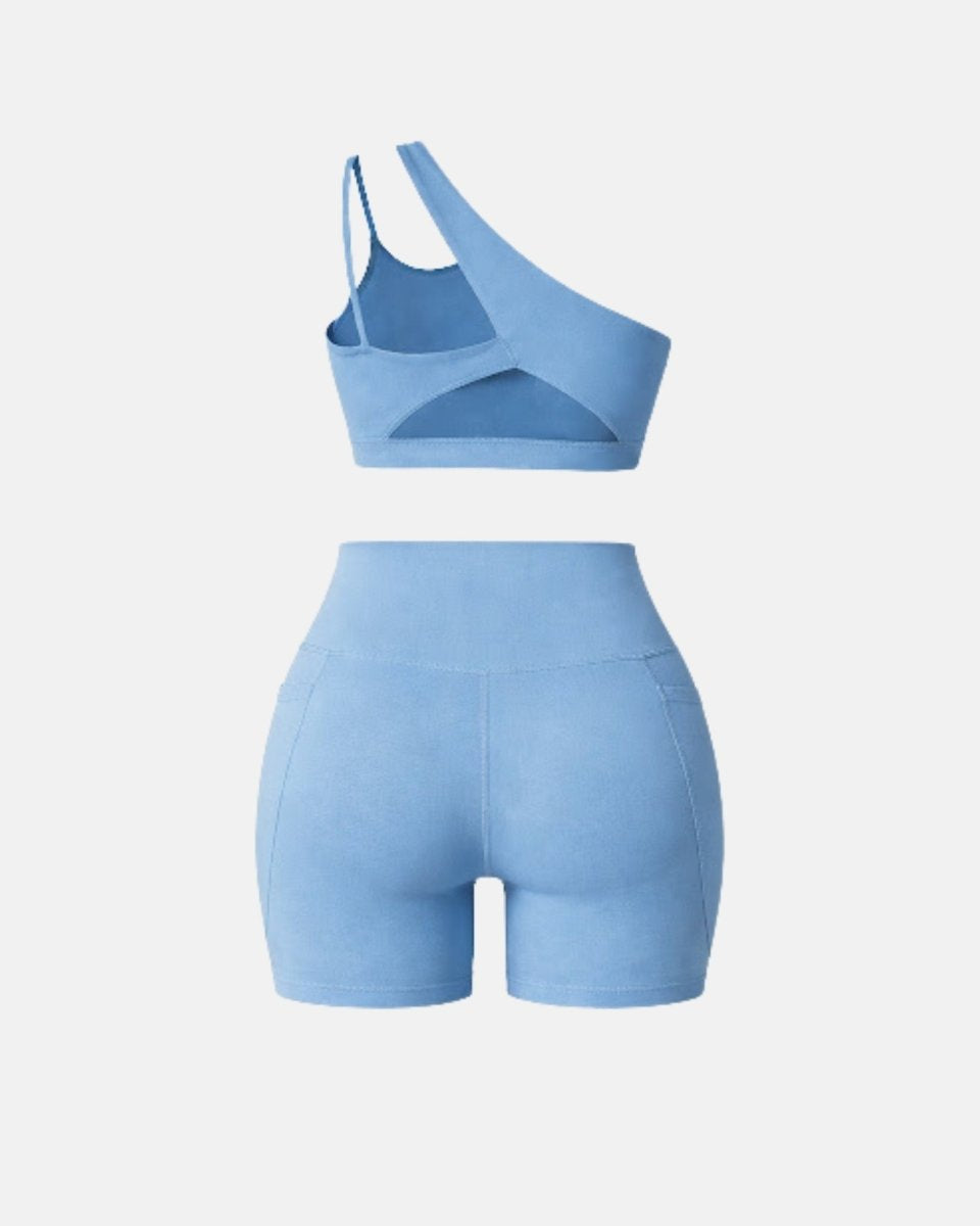 Back view of light blue matching workout set showing dual back strap design and high waisted short construction for women.