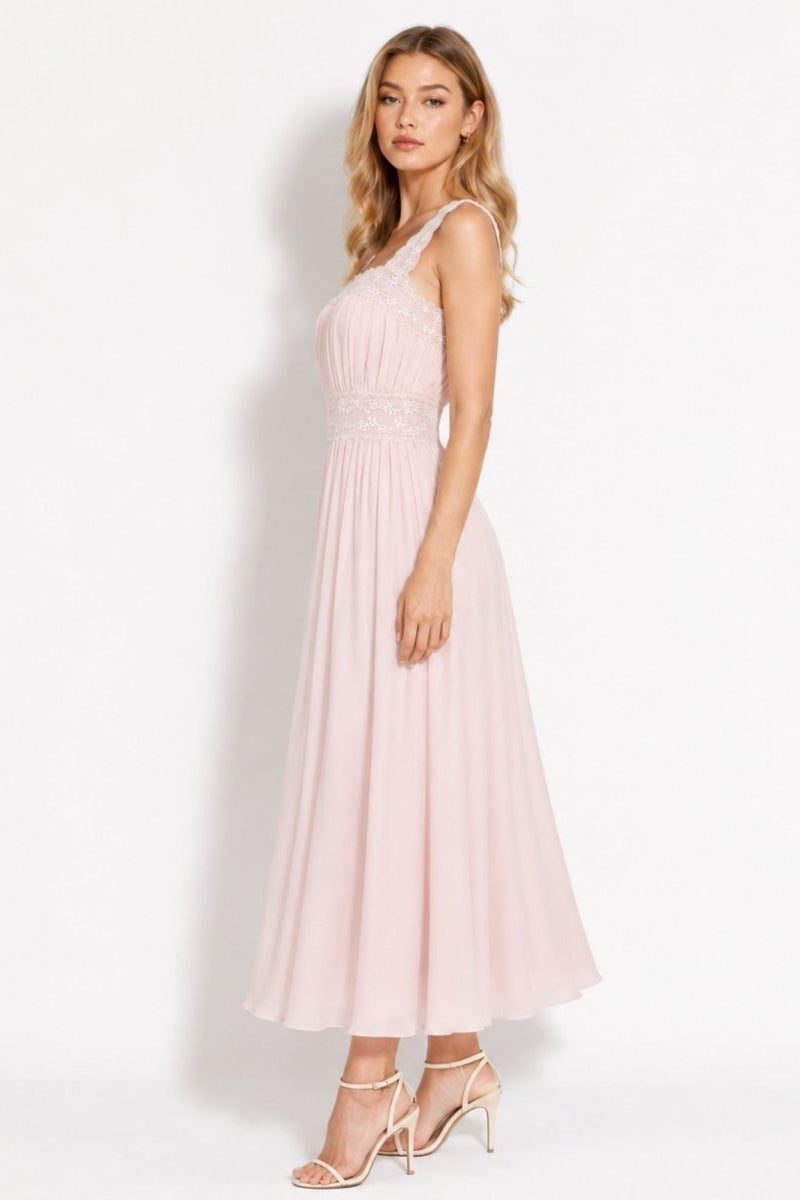Side view of luxury light pink flowy midi dress showing pleated bodice and delicate lace waist