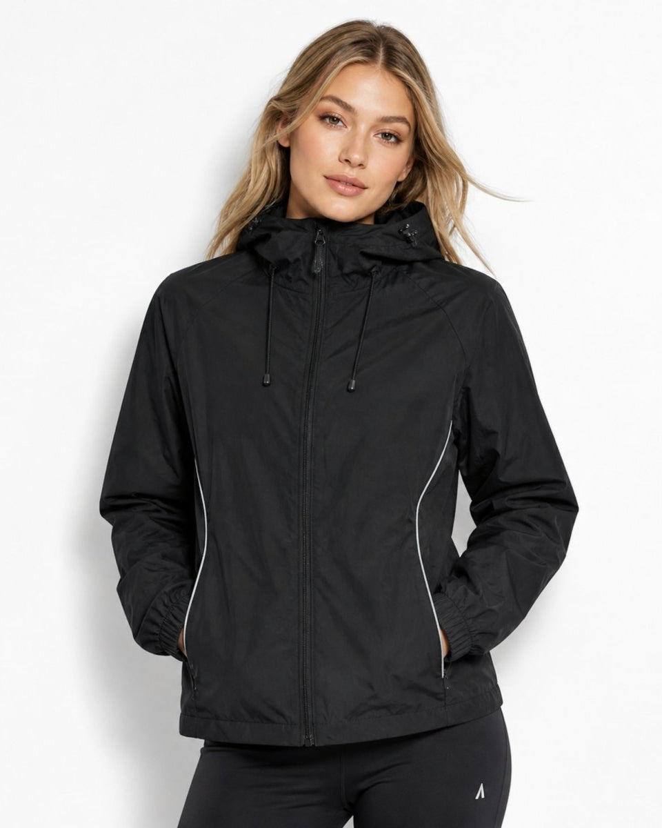 Woman wearing black lightweight hooded windbreaker jacket with front zipper and reflective trim.