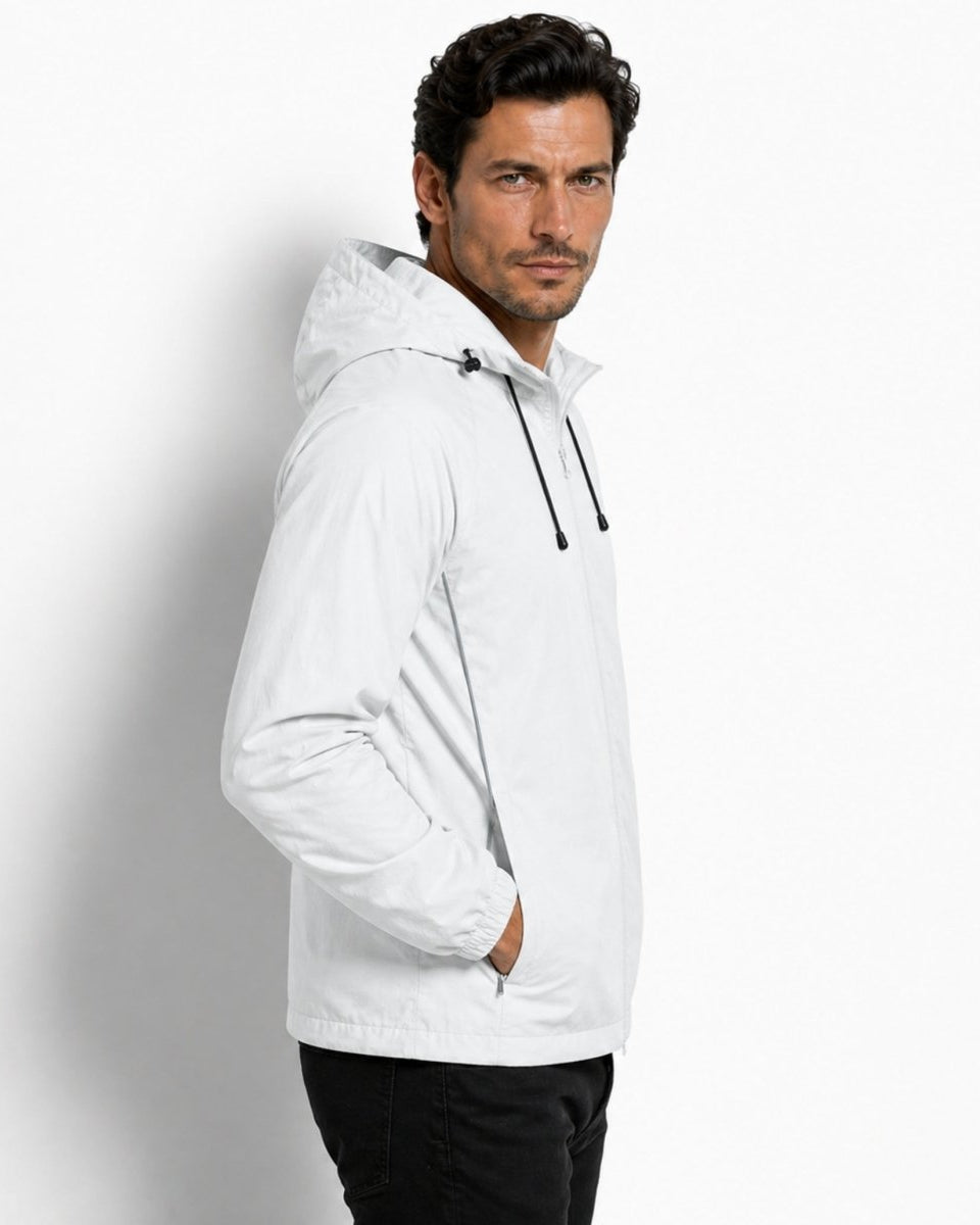 Side profile of a male model in a light grey water-resistant jacket highlighting the raglan sleeves and tailored hood design.