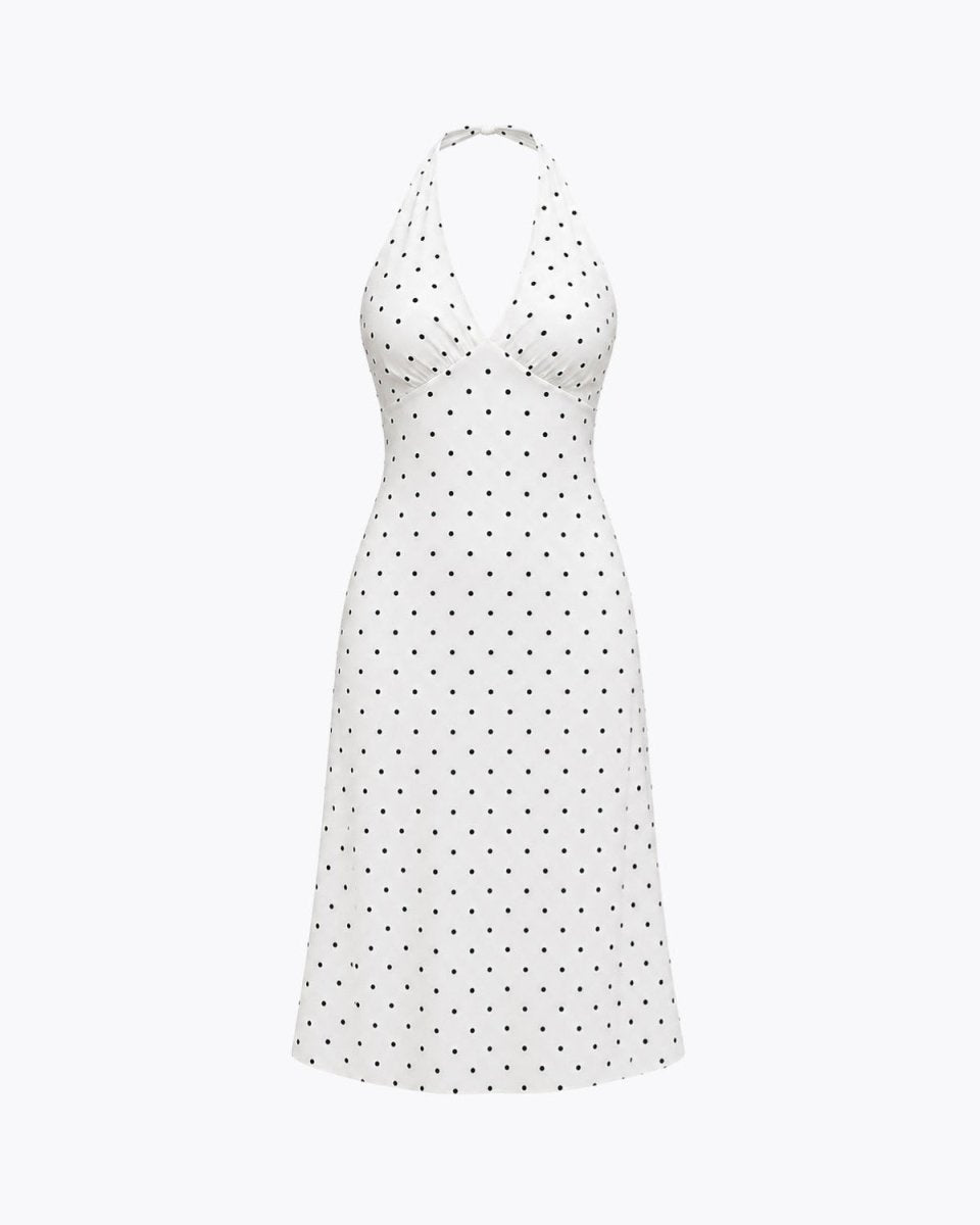 Flat lay studio shot of a white V-neck ruched bust polka dot midi dress showing garment shape and pattern details.
