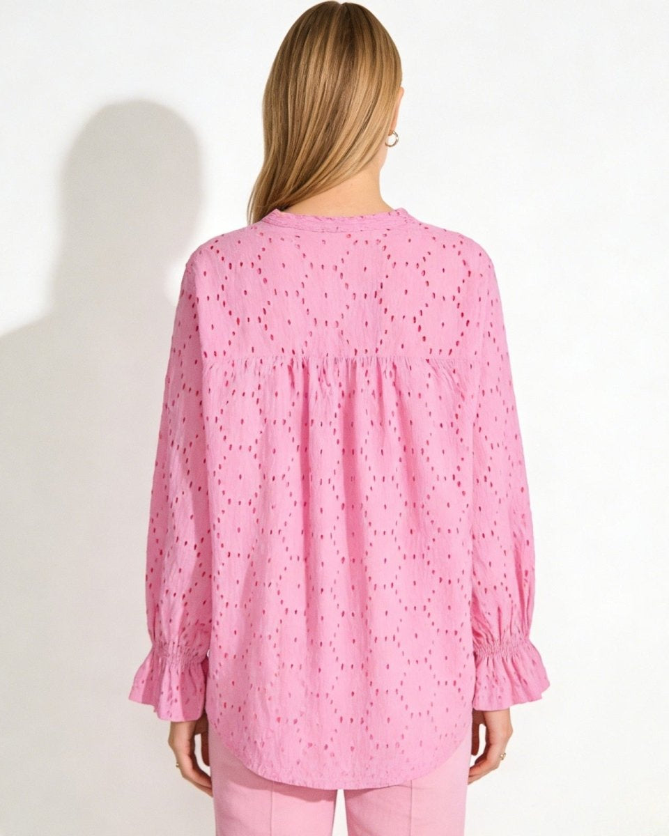 Back view of the Lydia pink cotton blouse, detailing the broderie anglaise pattern and gathering at the yoke.