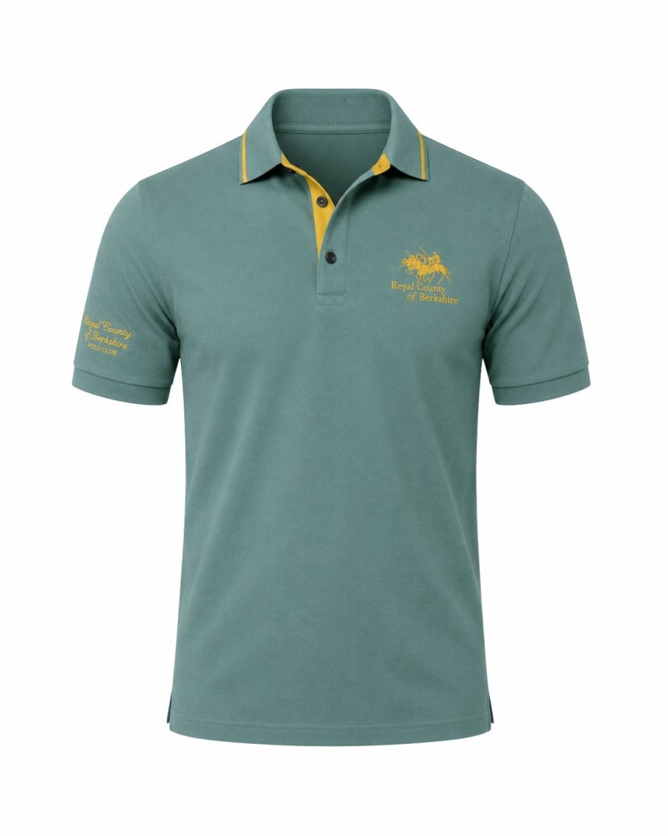 A short-sleeve polo shirt in a muted teal green color, featuring a yellow inner placket and collar trim, with yellow embroidered logos on the left chest and right sleeve, set against a plain white background.