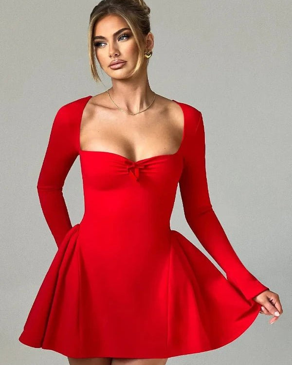 Red dress with long sleeves worn by a model on a gray background
