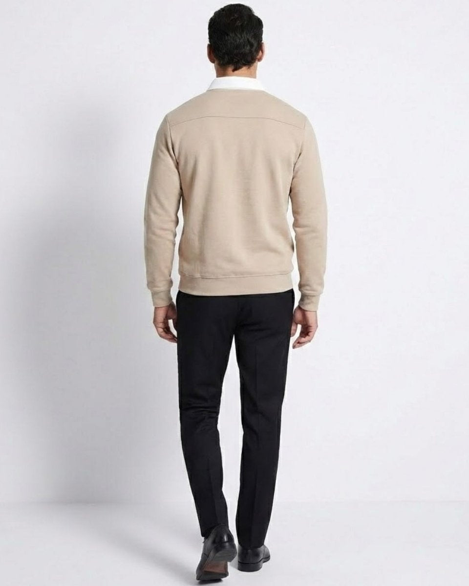 Back view of the men's light beige polo sweater, showing the yoke detail and fit across the shoulders.