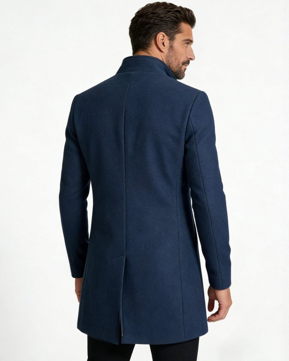 Back view of the men's blue wool overcoat showing the clean tailoring and single center vent.