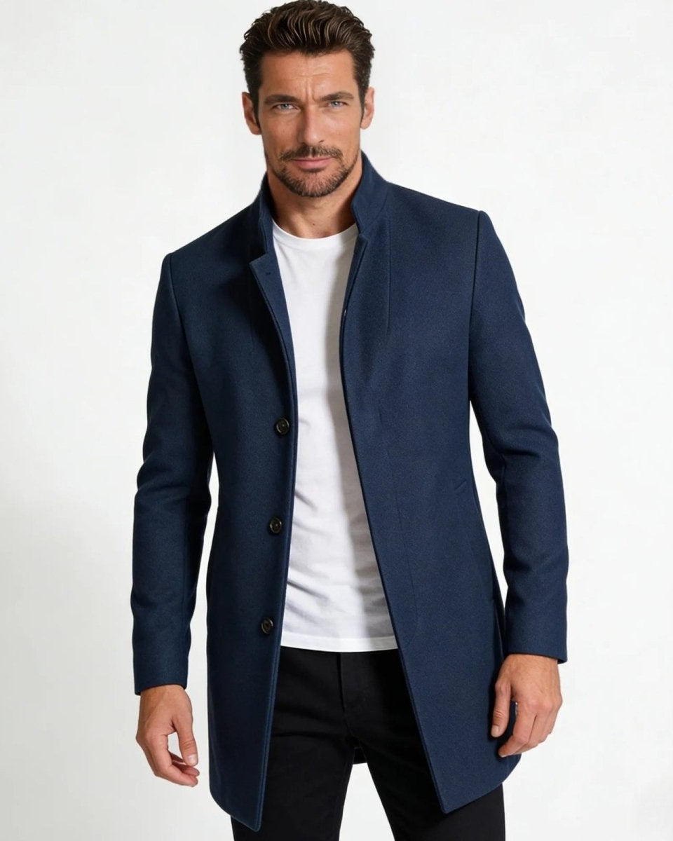 Model wearing the men's blue wool stand collar overcoat with a white t-shirt and black trousers.