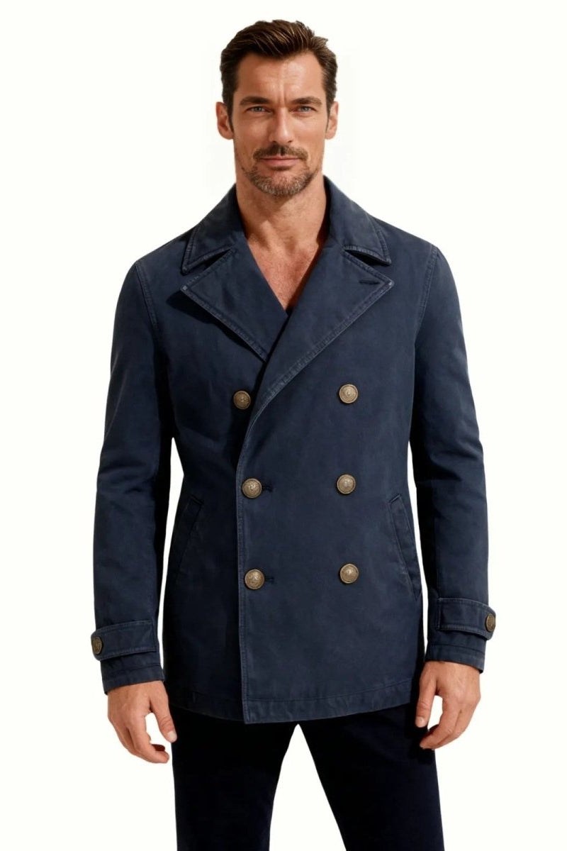 Model wearing the men's garment-dyed cotton peacoat in a washed navy blue, showing the classic double-breasted front and fit.