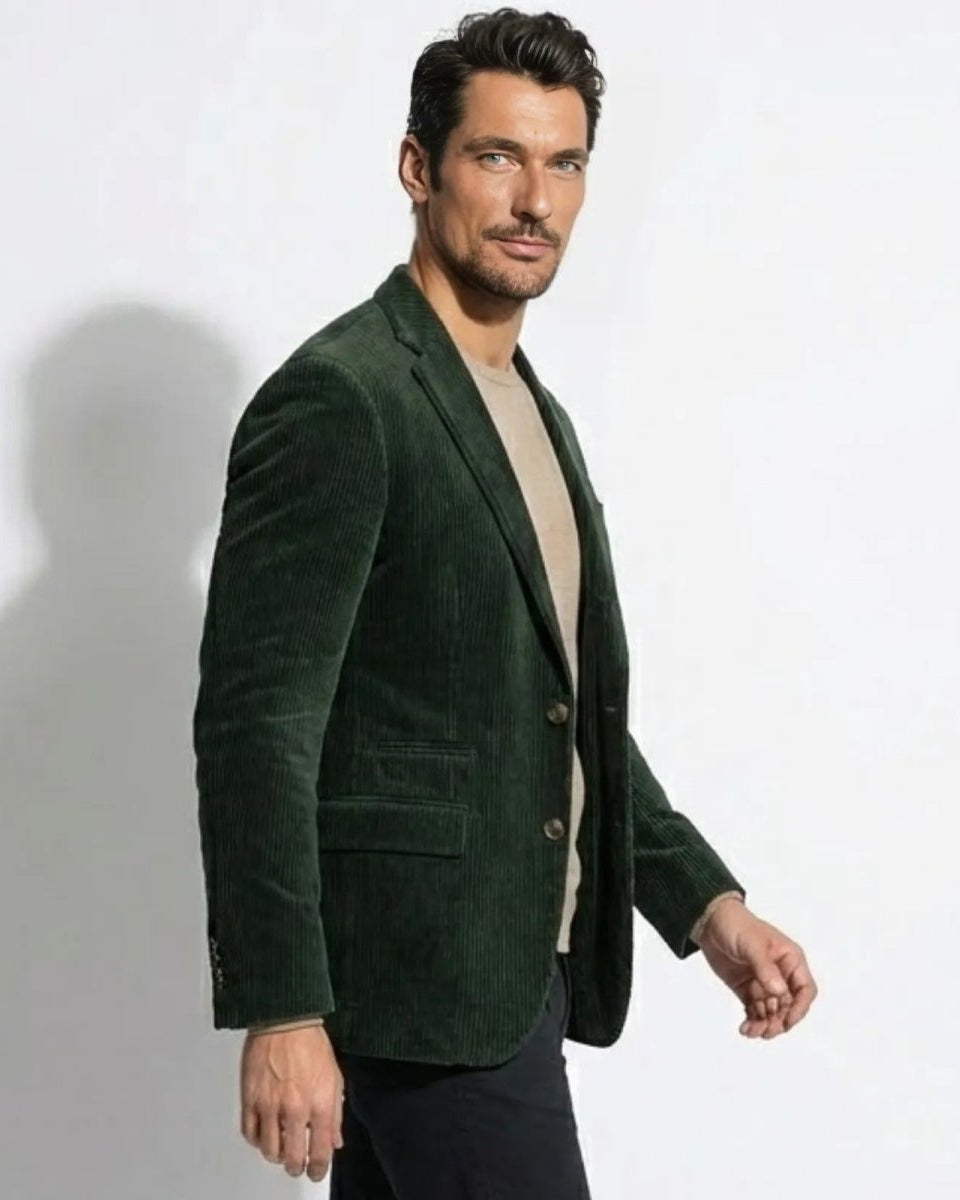 Side profile of a man in a forest green grady sport coat, highlighting the jacket's structure and drape while in motion.
