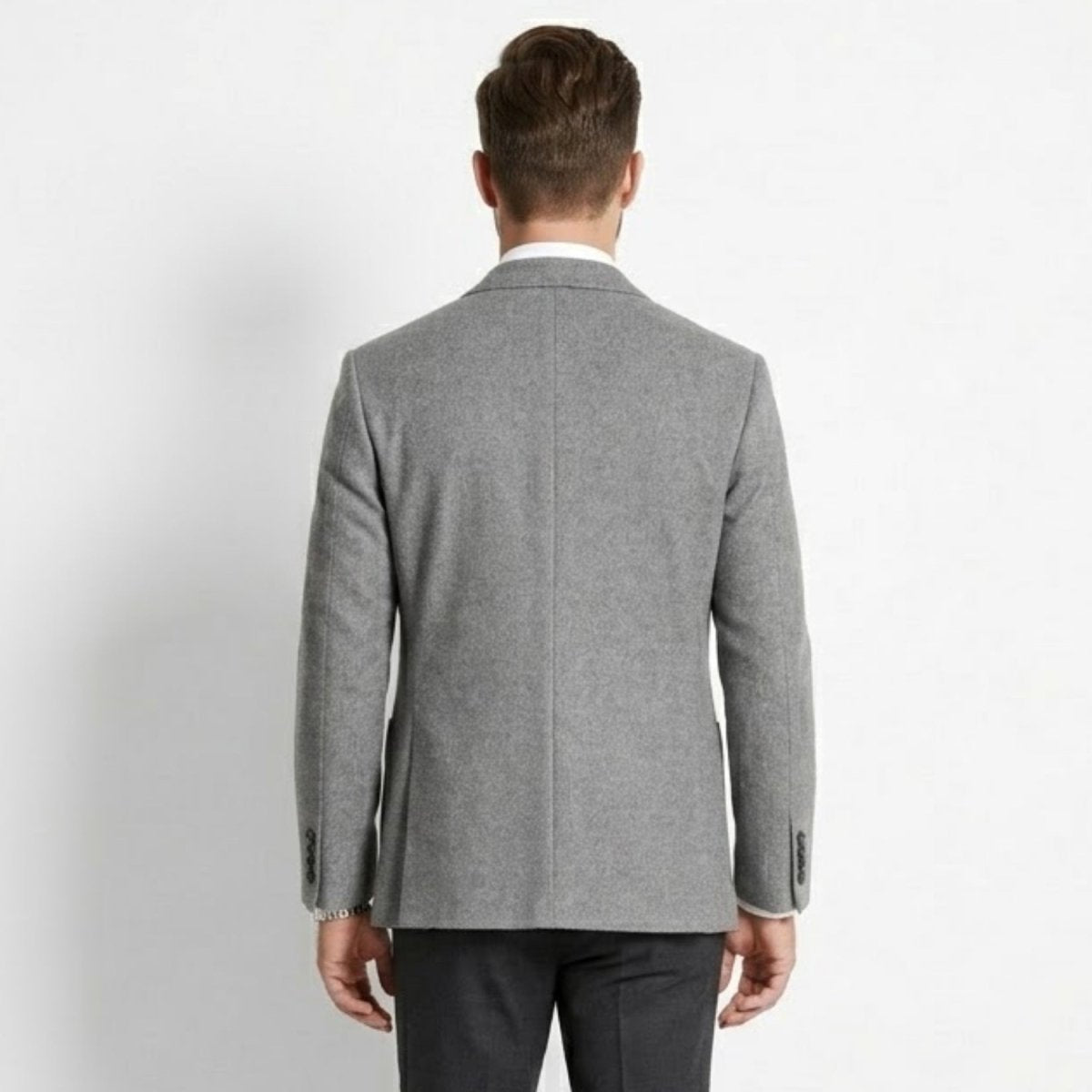 Back view of men's grey soft tailored sport coat showing ventless back design
