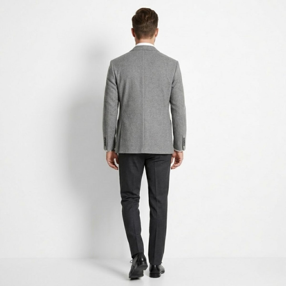 Back profile of man walking wearing a tailored grey winter blazer