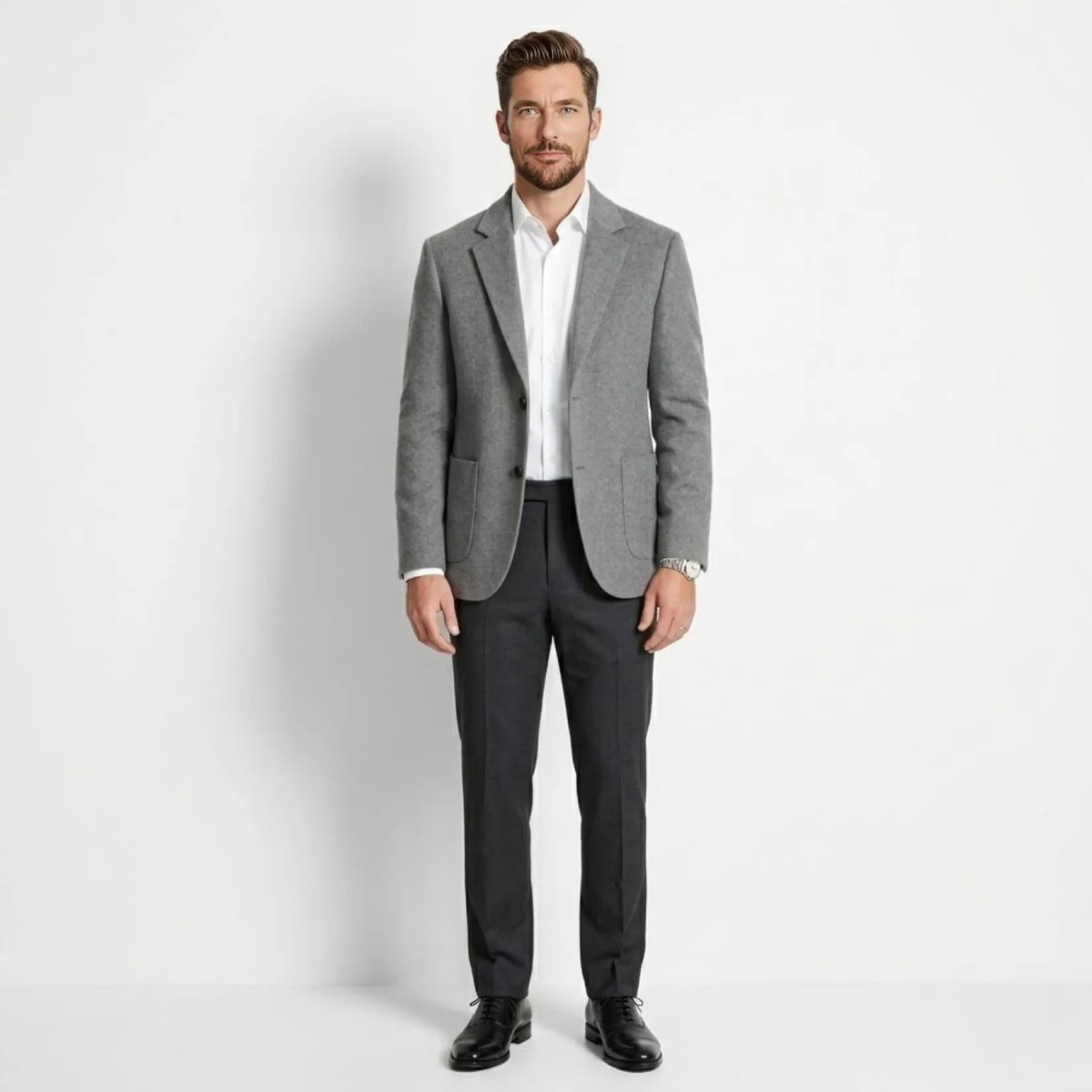 Full body shot of male model wearing smart casual grey blazer and dark trousers