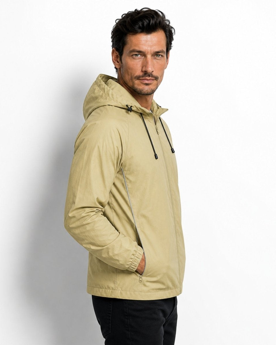 Side profile of male model wearing the light army green technical athletic outerwear showing reflective piping detail.