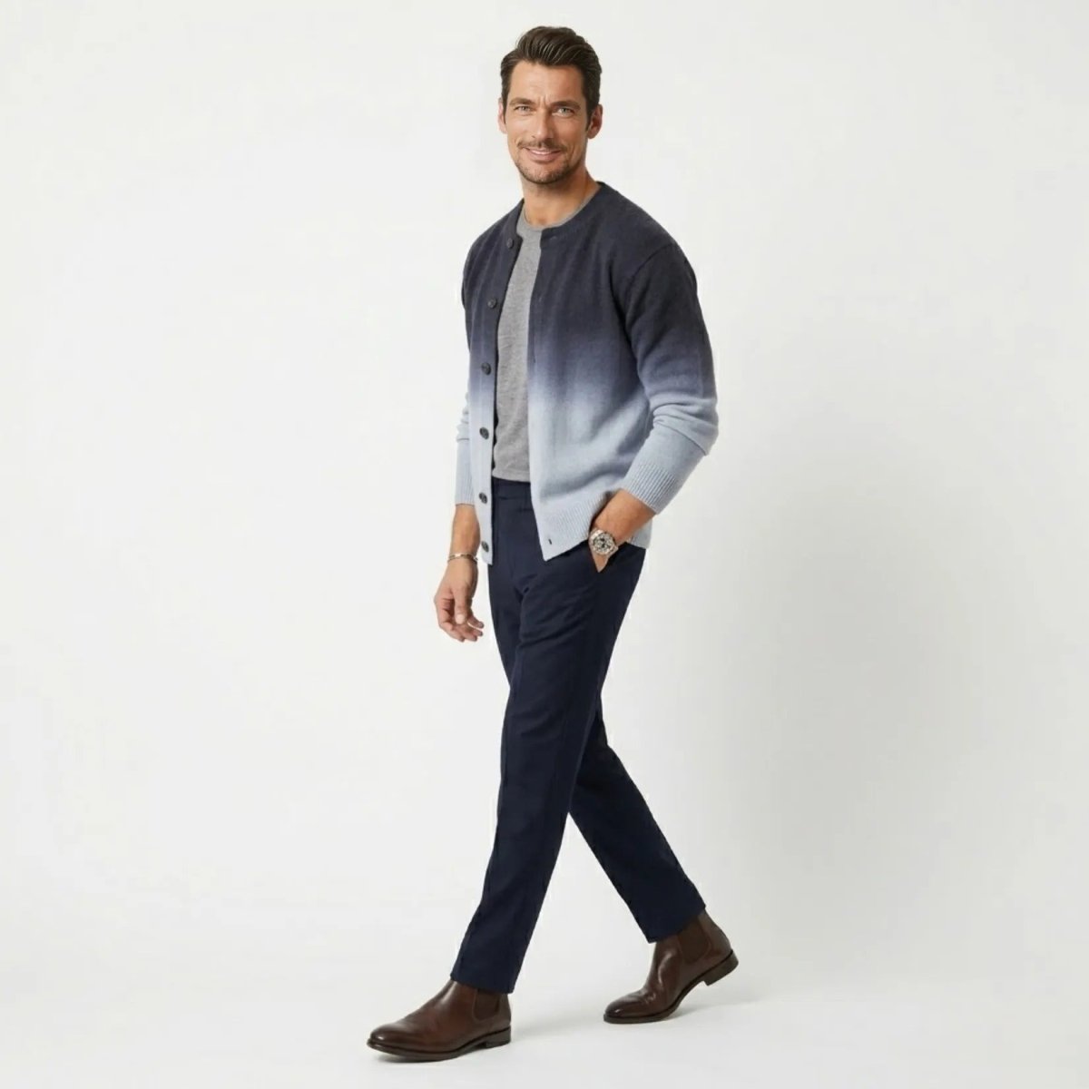 Side profile of male model walking in the Kouvr affordable luxury navy Theodore button-down cardigan sweater.