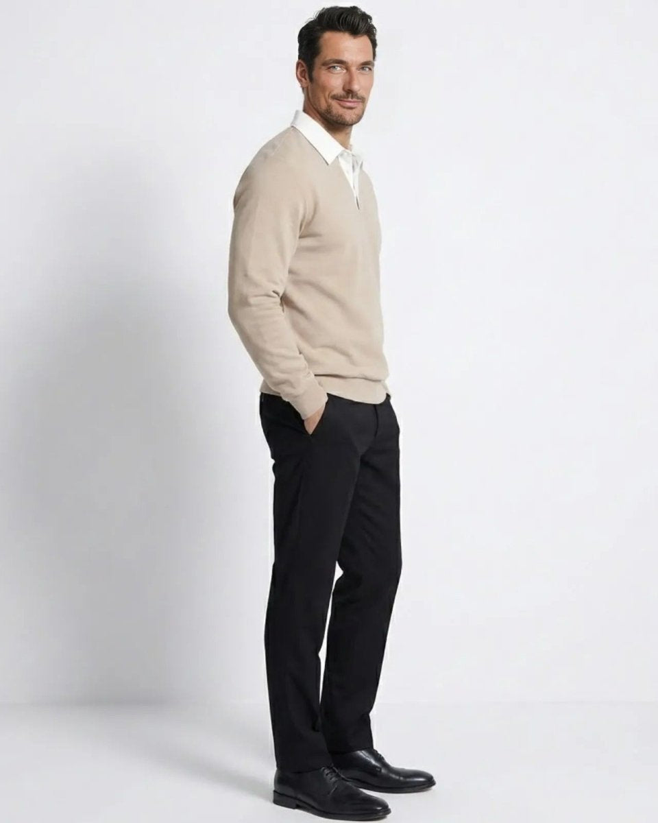 Side view of a man in the light beige collared pullover sweater, highlighting the silhouette and sleeve length.
