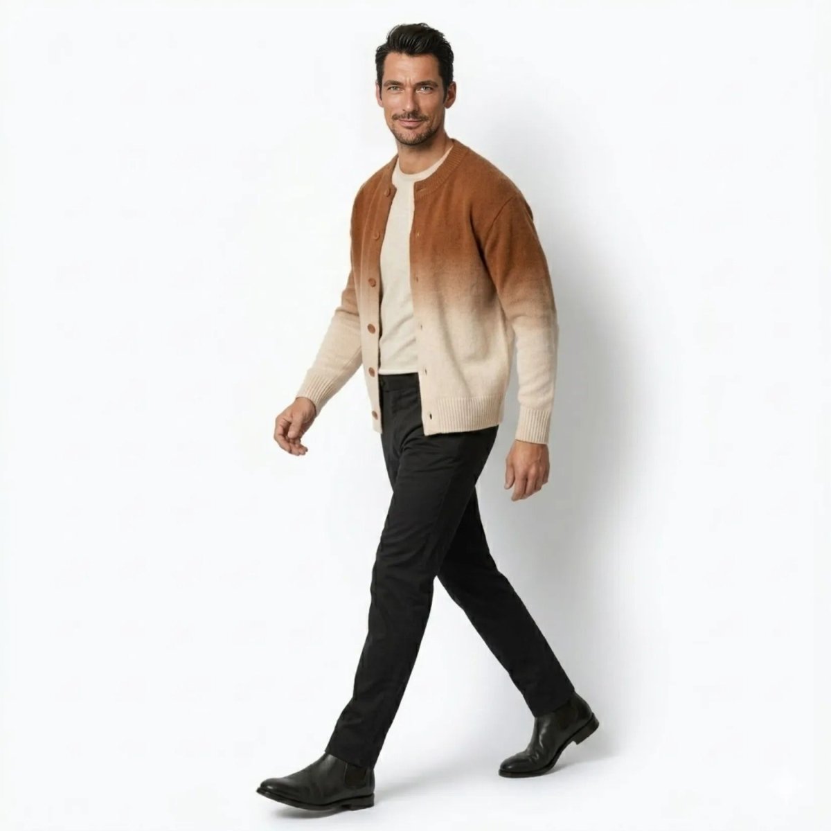 Profile view of a man walking wearing a premium rust khaki and cream gradient button-up cardigan sweater.