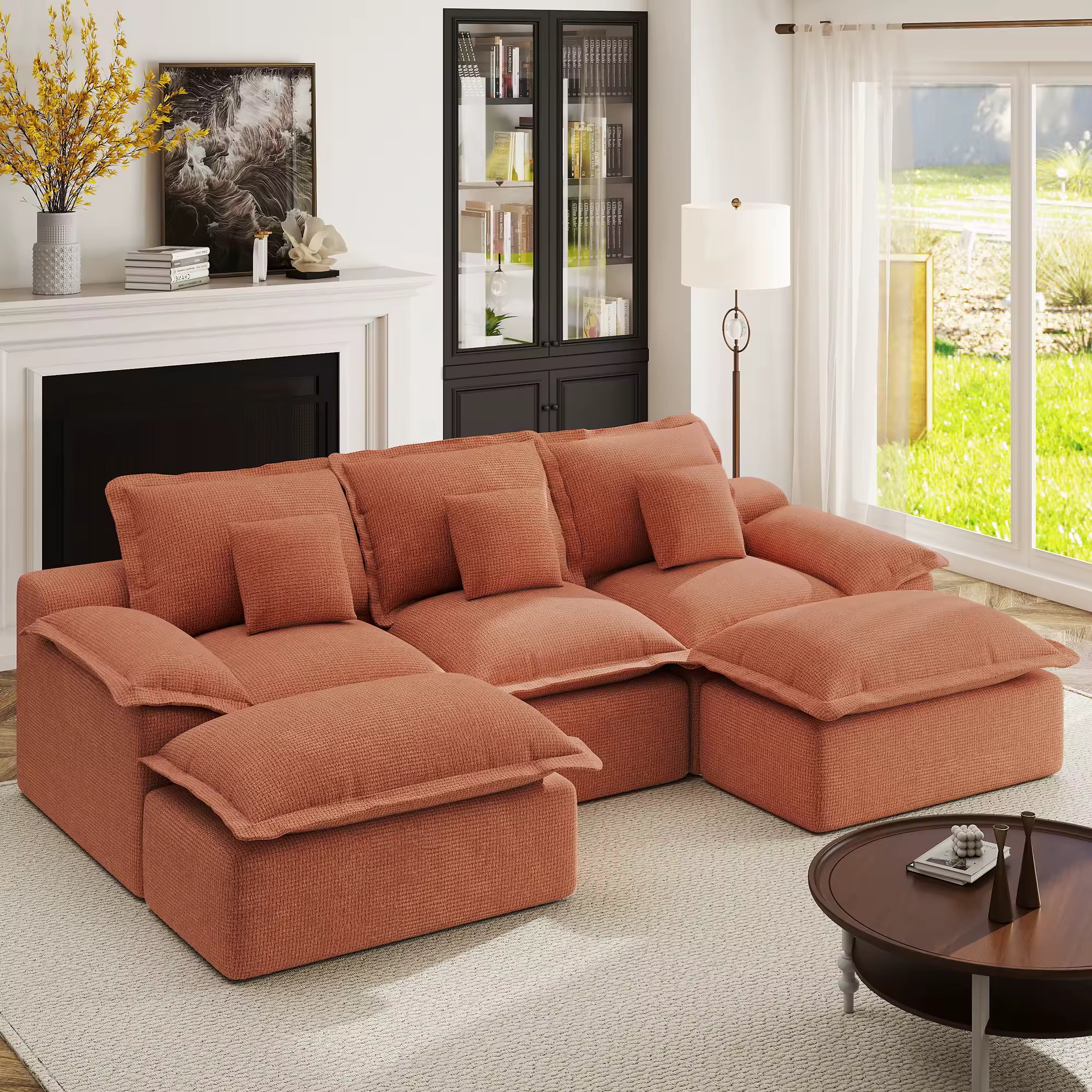Terracotta pit-style modular sofa contrasted against charcoal grey walls and a dark plush rug for a modern look.