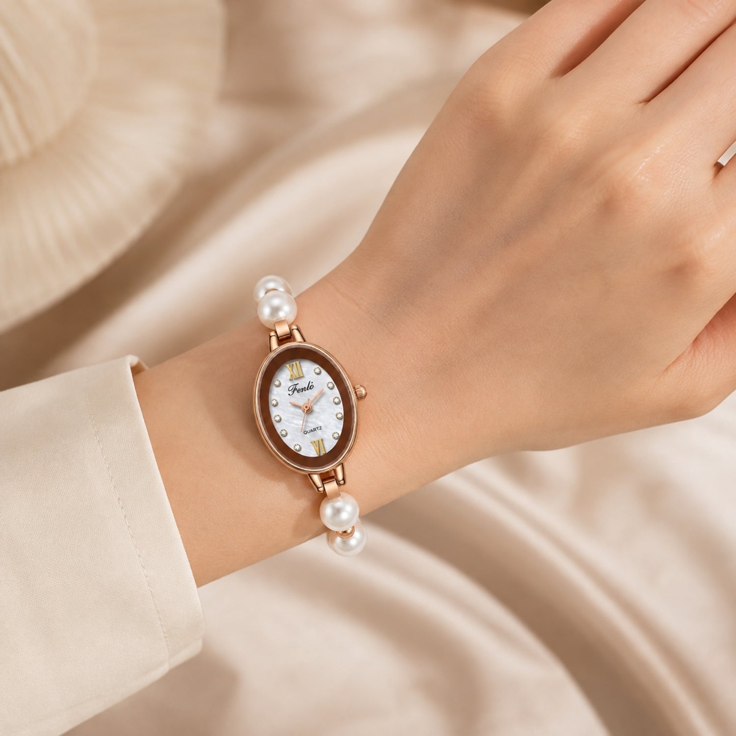 Detailed view of the women's rose gold watch on wrist, highlighting the shimmering mother of pearl dial, Roman numerals, and crystal hour markers.