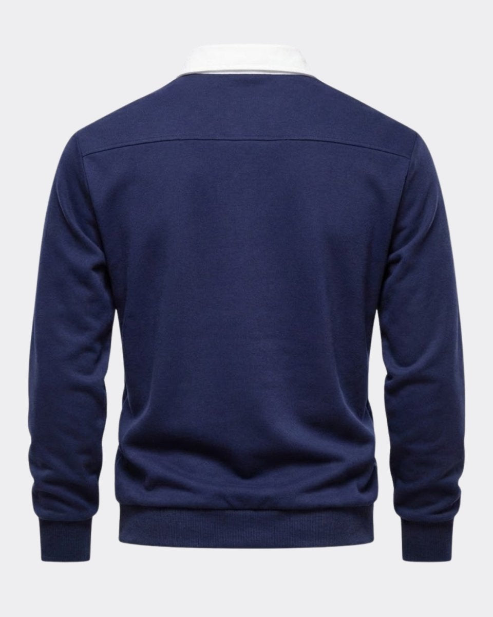 Back product shot of the navy polo, detailing the horizontal yoke seam across the shoulders and quality construction.