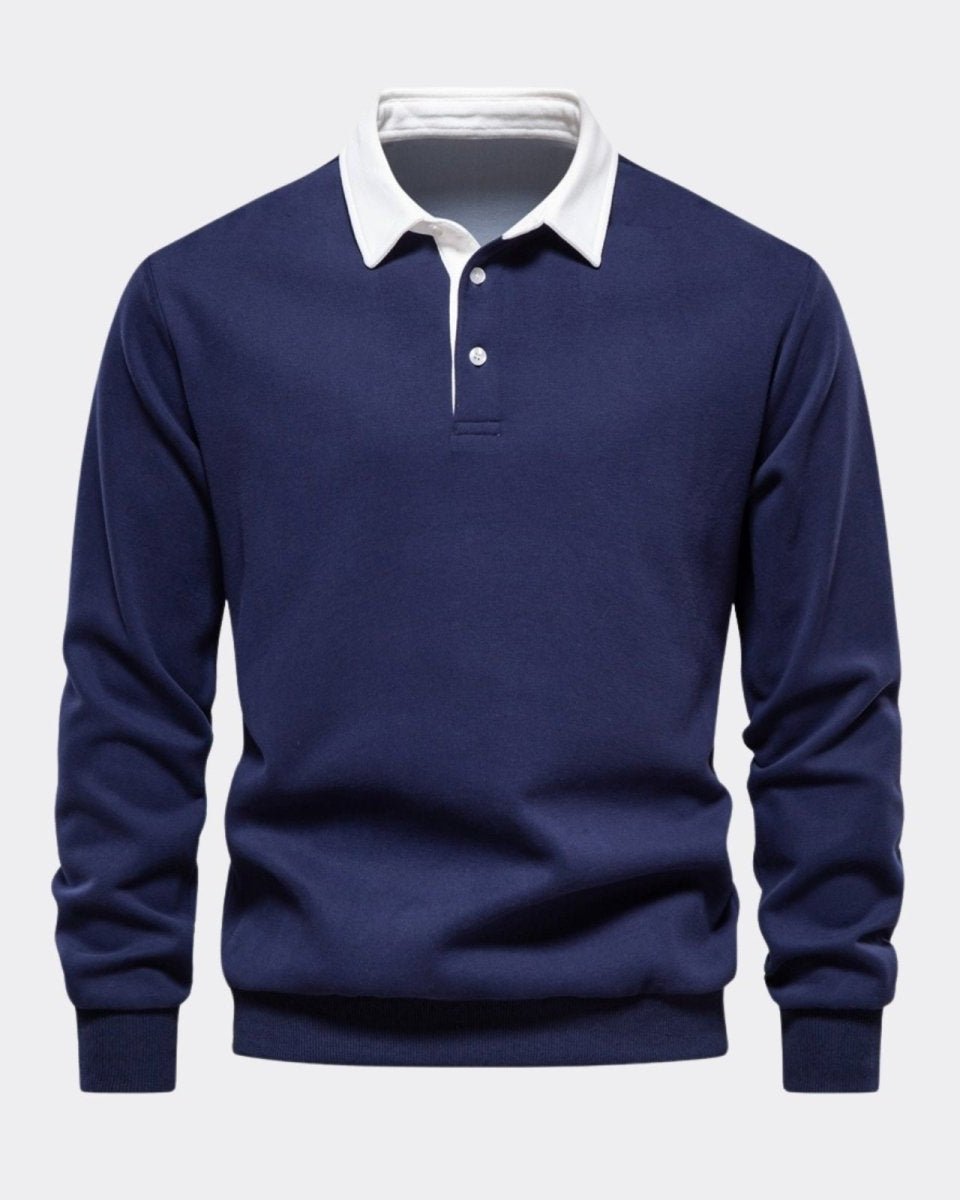 Product shot of the navy long sleeve polo sweater, laid flat to show the texture of the knit, three-button placket, and white collar.